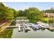 Overhead view of boat docks on a calm lake surrounded by verdant trees and waterfront houses at 5200 Woodmont Dr, Villa Rica, GA 30180