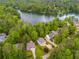Aerial view of a house with lake access, surrounded by lush greenery and mature trees in a peaceful neighborhood at 5200 Woodmont Dr, Villa Rica, GA 30180