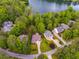 Aerial view of the house showcasing a spacious lot with mature trees and access to the lake at 5200 Woodmont Dr, Villa Rica, GA 30180