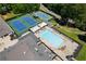 An aerial view featuring blue tennis courts, and a large swimming pool with lounge chairs at 5200 Woodmont Dr, Villa Rica, GA 30180
