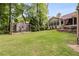 Well-maintained backyard with lush green lawn and charming chicken coop, with screened in porch at 5200 Woodmont Dr, Villa Rica, GA 30180