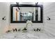 Bathroom showcasing a dual vanity with marble countertops and shiplap accent wall at 5200 Woodmont Dr, Villa Rica, GA 30180