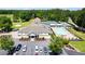 Aerial view of the clubhouse, tennis courts, pool, parking, and surrounding greenery at 5200 Woodmont Dr, Villa Rica, GA 30180