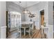 Elegant dining room with stylish light fixture, wainscoting, and shuttered window at 5200 Woodmont Dr, Villa Rica, GA 30180