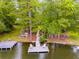 Picturesque waterfront featuring a dock with seating and picnic area, surrounded by mature trees and serene water views at 5200 Woodmont Dr, Villa Rica, GA 30180