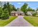 Beautiful single-Gathering home with a long driveway, a well-kept lawn, and mature trees at 5200 Woodmont Dr, Villa Rica, GA 30180