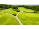 Well-manicured golf course featuring expansive greens, walking paths, and mature trees at 5200 Woodmont Dr, Villa Rica, GA 30180