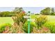 Golf course sign surrounded by colorful flowers, indicating tee locations and range at 5200 Woodmont Dr, Villa Rica, GA 30180
