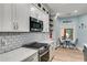 Bright kitchen with subway tile backsplash, stainless appliances, and an adjacent breakfast nook at 5200 Woodmont Dr, Villa Rica, GA 30180
