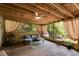 Screened-in porch featuring a ceiling fan and seating area, perfect for relaxing outdoors at 5200 Woodmont Dr, Villa Rica, GA 30180
