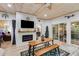 Stylish sunroom with wood-paneled ceiling, electric fireplace, and sliding doors to the backyard at 5200 Woodmont Dr, Villa Rica, GA 30180