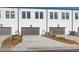 Townhome garages with driveway parking and neutral paint color at 896 Farmstead Rd # 162, Suwanee, GA 30024