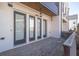 Exterior view of brick patio outside unit featuring a white brick exterior and three windows at 896 Farmstead Rd # 162, Suwanee, GA 30024