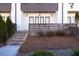 Close-up of front porch with brick steps, a wooden fence, and small bushes outside the front door at 896 Farmstead Rd # 162, Suwanee, GA 30024