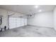 Spacious garage with concrete floor, a white garage door, and ample room for parking and storage at 896 Farmstead Rd # 162, Suwanee, GA 30024