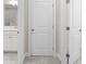 Hallway featuring three doors, neutral walls, and carpet at 896 Farmstead Rd # 162, Suwanee, GA 30024