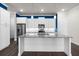 Modern kitchen with white island, cabinets, stainless appliances, granite countertops, and wood floors at 896 Farmstead Rd # 162, Suwanee, GA 30024