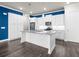 Modern kitchen features white cabinets, stainless appliances, granite countertops, and wood floors at 896 Farmstead Rd # 162, Suwanee, GA 30024