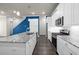 Well-lit kitchen with white cabinetry, granite countertops, stainless steel appliances, and dark wood floors at 896 Farmstead Rd # 162, Suwanee, GA 30024