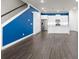 Open-concept kitchen features white cabinets, stainless appliances, granite countertops, and wood floors at 896 Farmstead Rd # 162, Suwanee, GA 30024