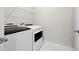A well-lit laundry room features a modern white washer and dryer set with convenient overhead shelving at 896 Farmstead Rd # 162, Suwanee, GA 30024