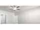 Open living room featuring a ceiling fan, multiple doorways, and neutral walls at 896 Farmstead Rd # 162, Suwanee, GA 30024