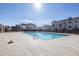 Community pool surrounded by houses and a black metal fence at 896 Farmstead Rd # 162, Suwanee, GA 30024