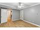 Spacious bedroom featuring wood floors, neutral walls, a ceiling fan, and a closet at 91 Rumson Ne Rd # B25, Atlanta, GA 30305