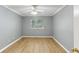 This bedroom offers neutral walls, light-colored wood floors, and a ceiling fan for added comfort at 91 Rumson Ne Rd # B25, Atlanta, GA 30305
