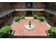 Aerial view of the property's charming courtyard featuring lush landscaping and water fountain at 91 Rumson Ne Rd # B25, Atlanta, GA 30305