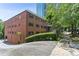 Charming brick building with green shutters surrounded by lush greenery and tall trees at 91 Rumson Ne Rd # B25, Atlanta, GA 30305