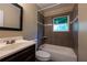 Bathroom with a white sink and tiled bathtub and shower with a window at 115 Delmoor Nw Dr, Atlanta, GA 30311