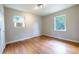 Cozy bedroom with hardwood floors, two windows, and a ceiling light at 115 Delmoor Nw Dr, Atlanta, GA 30311