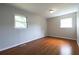 Bedroom featuring hardwood floors, neutral walls, and a window for natural light at 115 Delmoor Nw Dr, Atlanta, GA 30311