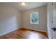 Bright bedroom with hardwood floors and a window overlooking a green view at 115 Delmoor Nw Dr, Atlanta, GA 30311