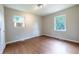Bright bedroom with hardwood floors, two windows, and neutral paint at 115 Delmoor Nw Dr, Atlanta, GA 30311