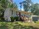 Charming grey-painted brick home with a front yard and wood porch steps at 115 Delmoor Nw Dr, Atlanta, GA 30311