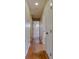 Hallway with hardwood flooring and white doors leading to other rooms at 115 Delmoor Nw Dr, Atlanta, GA 30311