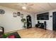 Finished basement with a ceiling fan, movie decor, a large screen TV, and wood-look floors at 128 Champion Way, Hiram, GA 30141