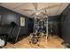 Basement gym featuring modern equipment with a treadmill, a bike and weight-lifting machine at 128 Champion Way, Hiram, GA 30141