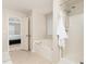 Bathroom featuring a shower stall, soaking tub, neutral color palette, and access to the main bedroom at 128 Champion Way, Hiram, GA 30141
