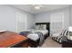 Comfortable bedroom with natural light, carpeted floor, ceiling fan, and a stylish chair at 128 Champion Way, Hiram, GA 30141