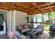 The covered deck is furnished with comfortable seating and offers a relaxing outdoor living space with a view at 128 Champion Way, Hiram, GA 30141