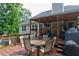 A spacious wooden deck features a dining table and chairs, offering an inviting outdoor living space at 128 Champion Way, Hiram, GA 30141
