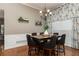 Stylish dining room featuring modern lighting, unique wall decor, and seating for six at 128 Champion Way, Hiram, GA 30141