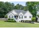 Charming home with a well-manicured lawn, blue door, fresh landscaping, and black shutters at 128 Champion Way, Hiram, GA 30141