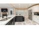 A kitchen island with granite countertops and a stainless steel refrigerator and microwave at 128 Champion Way, Hiram, GA 30141