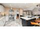 An open-concept kitchen with stainless steel appliances, granite countertops and breakfast bar seating at 128 Champion Way, Hiram, GA 30141