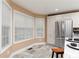 A kitchen with a dining nook featuring lots of natural light, granite countertops and stainless appliances at 128 Champion Way, Hiram, GA 30141