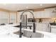 A modern kitchen features stainless steel appliances, granite countertops, and a chef's faucet at 128 Champion Way, Hiram, GA 30141